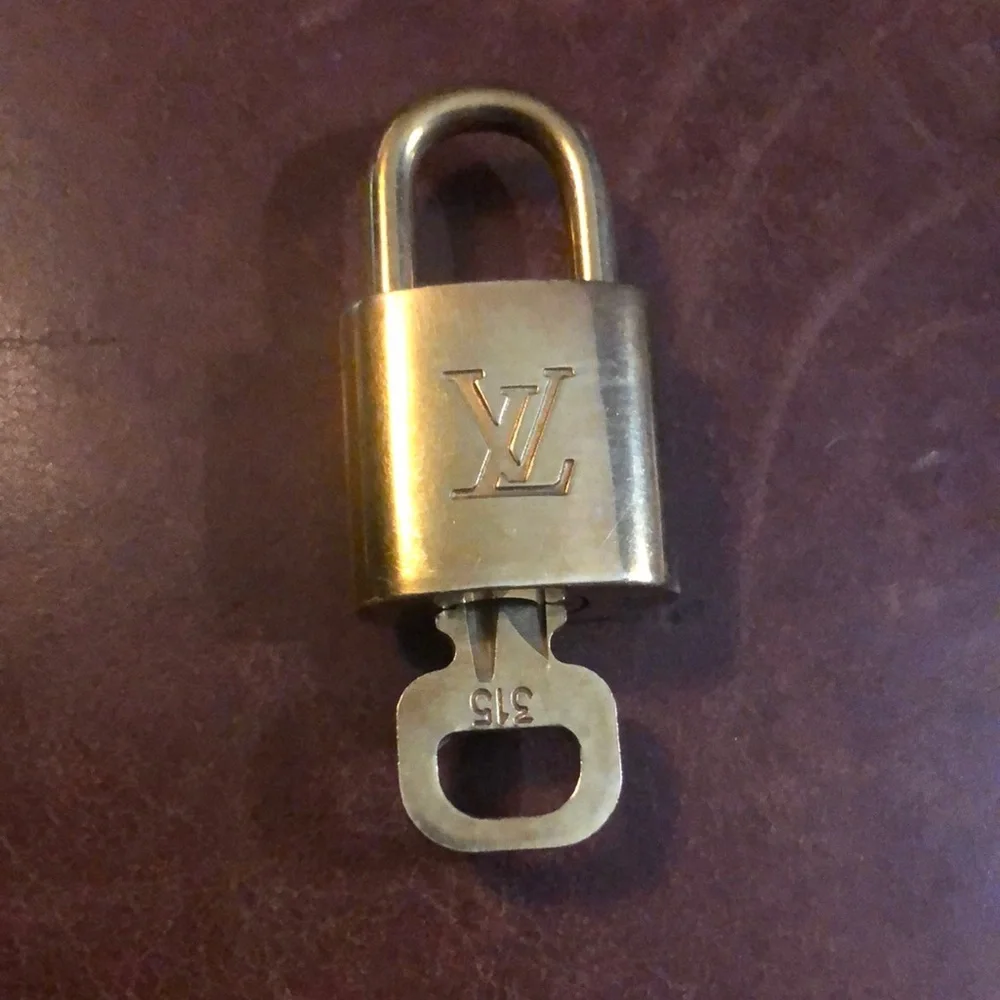 Louis Vuitton gold padlock and key set